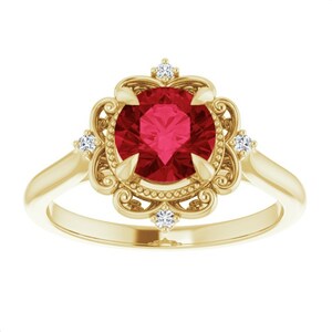 May include: A gold ring featuring a large, round, vibrant red gemstone at the center. The gemstone is surrounded by a decorative, floral-inspired setting with small, sparkling accent stones. The band is a simple, polished gold.