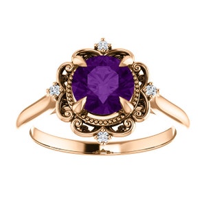 May include: A rose gold ring featuring a large, round, purple amethyst gemstone set in a filigree design with smaller diamonds around the centre stone.