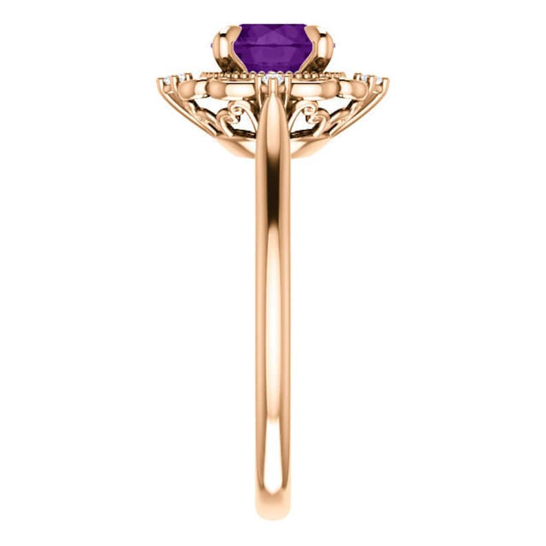 May include: A rose gold ring featuring a purple amethyst gemstone set in a delicate filigree design.