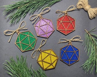 May include: Five wooden ornaments shaped like dice with glitter in different colors: purple, red, green, blue, and yellow.