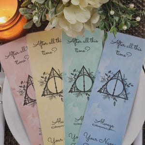 May include: Four colorful bookmarks with the text "After all this time?" and a Deathly Hallows symbol. The bookmarks are in shades of pink, yellow, green, and blue, with space for personalization.