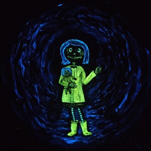 May include: A glowing green illustration of a girl with blue hair and a skeletal face, holding a doll and a small object. She wears a green dress and boots, with a blue swirling background.