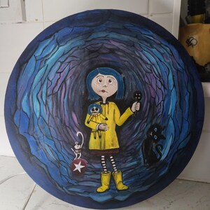 May include: A round painting featuring a girl in a yellow raincoat holding a button and a doll. A black cat and a skeleton with a star are also depicted. The background is a dark blue tunnel.