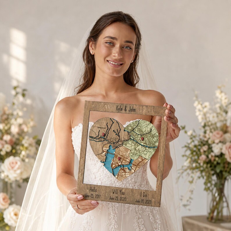A bride in her wedding dress holds the framed heart puzzle map personalized with names and dates. This lifestyle image positions the piece as a meaningful wedding gift or engagement keepsake for a couple.