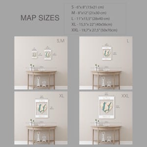 May include: A comparison of different sizes for a heart-shaped map print. The print is on a white background with a light blue heart shape. The sizes are labeled S, M, L, XL, and XXL. The measurements are in inches and centimeters.