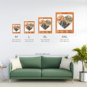 Size chart shows the framed heart puzzle keepsake in multiple dimensions above a sofa for scale comparison. This image helps buyers choose the best size for wall display in their home.