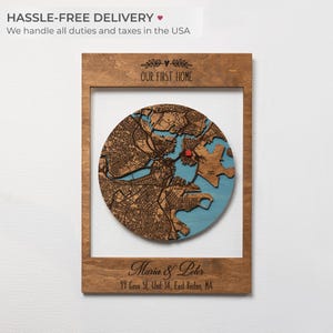 Personalized Our First Home wood map with a round layered city map and red house marker, shown with custom names and move-in date as a housewarming gift with hassle-free USA delivery.