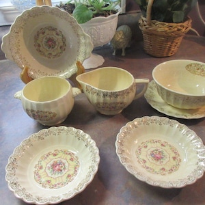 T1 Aristocrat dishes Imperial Ware 7 pieces 22-K gold flowers gold trim.