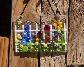 Garden gate picket fence Fused Glass Suncatcher featuring a garden view with blue delphinium, poppies, wildflowers and sunflowers. (4" x 6")