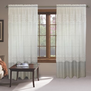 May include: A pair of white sheer curtains with a decorative embroidered pattern and a solid gray bottom panel. The curtains are hung on a silver curtain rod.