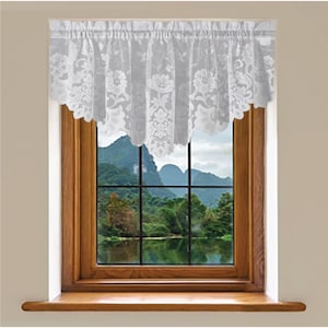 Puede incluir: Valance de encaje blanco con borde festoneado, colgando en una ventana con vista a un lago y montañas.
