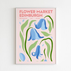 May include: A pink poster with the text "FLOWER MARKET EDINBURGH" in white and pink lettering. The poster features a stylized illustration of blue bell flowers with green leaves on a pink background.