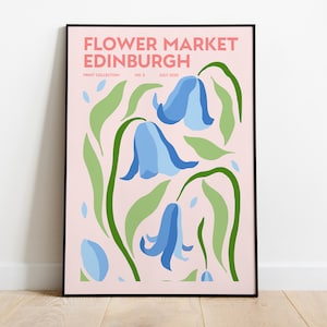 May include: A pink poster with the text "FLOWER MARKET EDINBURGH" in black lettering. The poster features a stylized illustration of blue bell flowers with green leaves on a pink background.