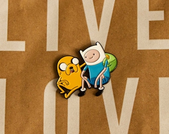 May include: A yellow dog and a blue boy with a green backpack are holding hands. They are cartoon characters from the show Adventure Time. The characters are on a brown background with the word "LIVE" written in white letters.