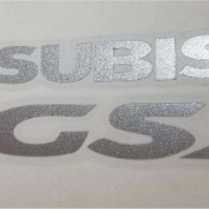 May include: Silver Mitsubishi GSX emblem with red Mitsubishi logo and the text "1995-99".