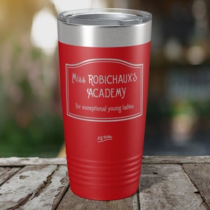 May include: Red stainless steel tumbler with a white inscription that reads "Miss Robichaux's Academy for exceptional young ladies" and "J.G. Willie" at the bottom.
