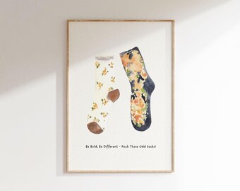 May include: A framed print with a watercolor illustration of two mismatched socks with floral patterns. The text "Be Bold. Be Different. Rock Those Odd Socks!" is printed below the socks.
