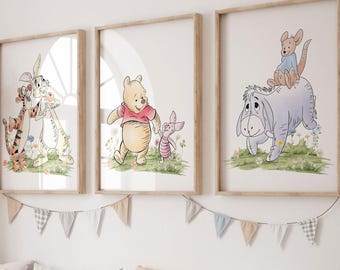 May include: Three framed watercolor prints featuring Winnie the Pooh characters: Tigger and Rabbit, Winnie the Pooh and Piglet, and Eeyore with Roo. The prints are displayed above a wooden storage bench with pillows and storage bins. A garland of pennants hangs above the prints.