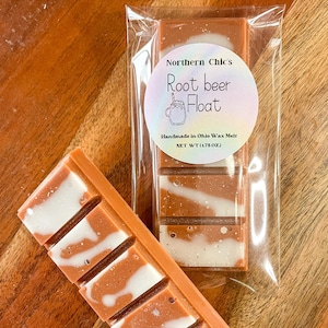 May include: A brown and white wax melt bar with the text "Northern Chic's Root beer Float Handmade in Ohio Wax Melt NET WT (1.75 OZ)" on a white label.