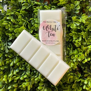 May include: A white wax melt bar with the text "Northern Chic's White Tea" and "Handmade in Ohio Wax Melt, NET WT (1.75 OZ)" on the packaging.