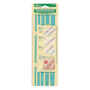 May include: A set of four Clover Loop Pressing Bars in a clear plastic pack. The bars are turquoise blue and are used for pressing fabric loops. The pack includes instructions on how to use the bars.