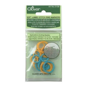 May include: A pack of Clover Soft Jumbo Stitch Ring Markers. The pack contains 20 markers, 10 small and 10 large. The markers are blue and yellow. The pack also includes a small sample of knitted fabric with a needle.