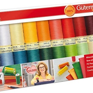 May include: A Gütermann Creativ value pack containing twelve spools of 100-metre sew-all thread in a spectrum of colours including black, white, yellow, orange, red, and green. The packaging features the brand name, product details, and images.