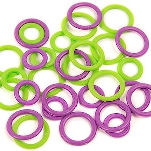May include: A collection of plastic rings in purple and green colours. The rings are of various sizes and are arranged in a random pattern.