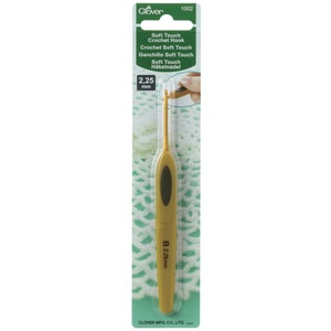 May include: A gold-coloured crochet hook with a black handle. The hook is labelled "Soft Touch Crochet Hook" and "2.25 mm".