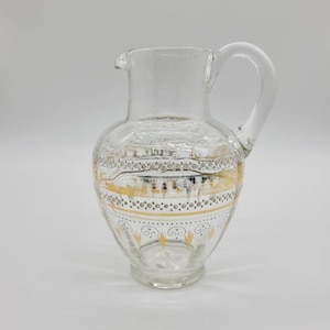 Vintage Glass Pitcher embellished with gold and white design.