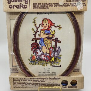May include: A vintage Hummel stitchery kit featuring a girl with a rooster and chicks. The kit includes a 9x12 inch frame, stamped fabric, floss, needle, and easy-to-follow instructions. The kit is titled "Farm Girl" and is number 8039.