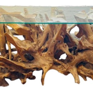 May include: A rectangular coffee table with a clear glass top. The base is made of intricately arranged, light brown, natural wood roots. The table has a unique, organic design, perfect for a living room.