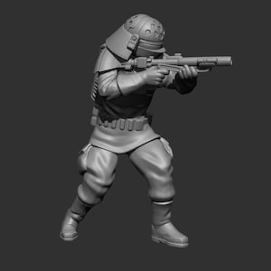 Op de afbeelding: Een grijs 3D-geprint miniatuur van een soldaat met een helm en een geweer. De soldaat staat in een schietpositie.