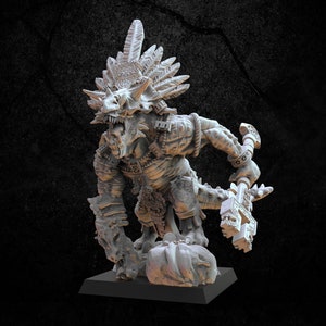 May include: A detailed, gray figurine of a reptilian humanoid creature with feathered headdress and ornate armor. The figure is holding a weapon and stands on a small base. The creature has a fierce expression and intricate detailing.