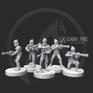May include: Five grey plastic miniature figures of clone troopers from the Star Wars universe, each holding a blaster rifle. The figures are standing on circular bases.