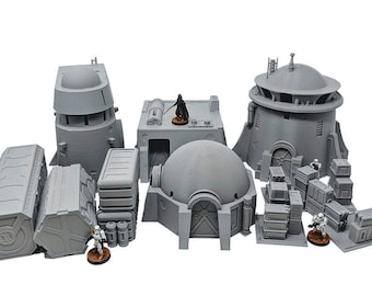 Peut inclure: Un ensemble de bâtiments et de figurines miniatures imprimés en 3D gris pour un jeu de table ou un diorama. L'ensemble comprend un bâtiment en forme de dôme, deux tours, plusieurs bâtiments rectangulaires et deux figurines.