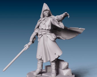May include: A gray painted miniature figurine of a person wearing a hooded cloak and holding a lightsaber. The figure is standing on a rocky base.