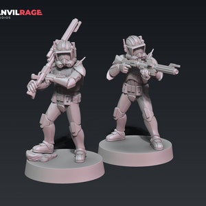 May include: Two grey plastic action figures of clone troopers from the Star Wars universe. The figures are holding blasters and are standing on circular bases.