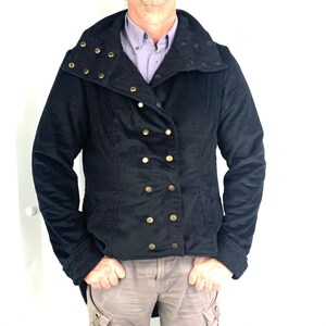 May include: A black jacket with a high collar and gold buttons. The collar has decorative studs.