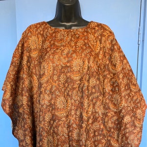 Warm soft cosy Handmade Blanket Poncho in browns oranges & yellows with a mustard fringe. Autumn colours