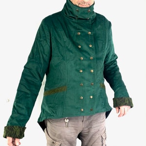 May include: A dark green velvet jacket with a high collar and gold buttons. The jacket has a long tail and decorative trim on the sleeves and hem.