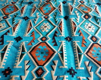 May include: Turquoise fabric with a geometric pattern in shades of orange, green, black, and white.