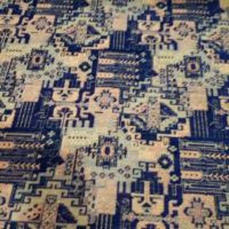 May include: A woven rug featuring a dense, repeating geometric pattern in deep navy blue and light beige. The design consists of intricate, angular motifs, interconnected lines, and symmetrical shapes that cover the entire surface of the textile.