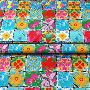 May include: A vibrant fabric featuring a repeating pattern of colorful floral designs. The squares showcase flowers in shades of red, pink, yellow, and blue, set against a white background. The overall design is reminiscent of a patchwork quilt.