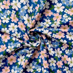 May include: A vibrant fabric with a repeating floral pattern. The design features white, pink, and light blue flowers with yellow centers, set against a deep blue background. The fabric is likely cotton or a similar material.