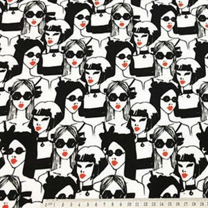 May include: Black and white fabric featuring a repeating pattern of stylized women's faces. Each woman wears sunglasses and has red lipstick. The women are dressed in black and white outfits. A ruler is at the bottom of the image.