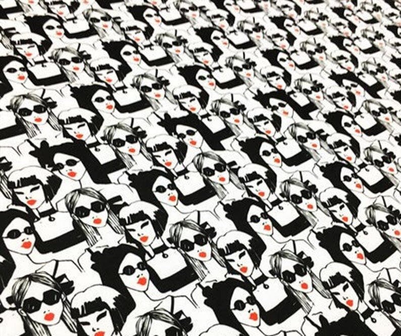 May include: A repeating pattern of stylized women's faces in black and white. Each face has red lipstick and sunglasses. The women are wearing black tops and chokers. The overall design is a modern, graphic print.