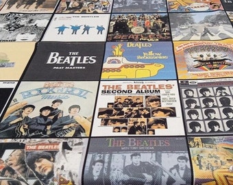 May include: A patchwork design featuring album covers of The Beatles. The squares display iconic album art, including "Yellow Submarine," "Abbey Road," and "Rock 'n' Roll Music." The design is a collage of album covers, showcasing the band's history.