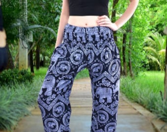May include: Black and grey patterned trousers with a repeating elephant design. The trousers have a wide leg and an elastic waistband.