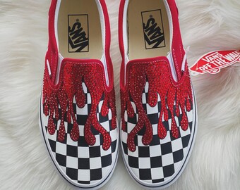 checkerboard slip on vans with red drip